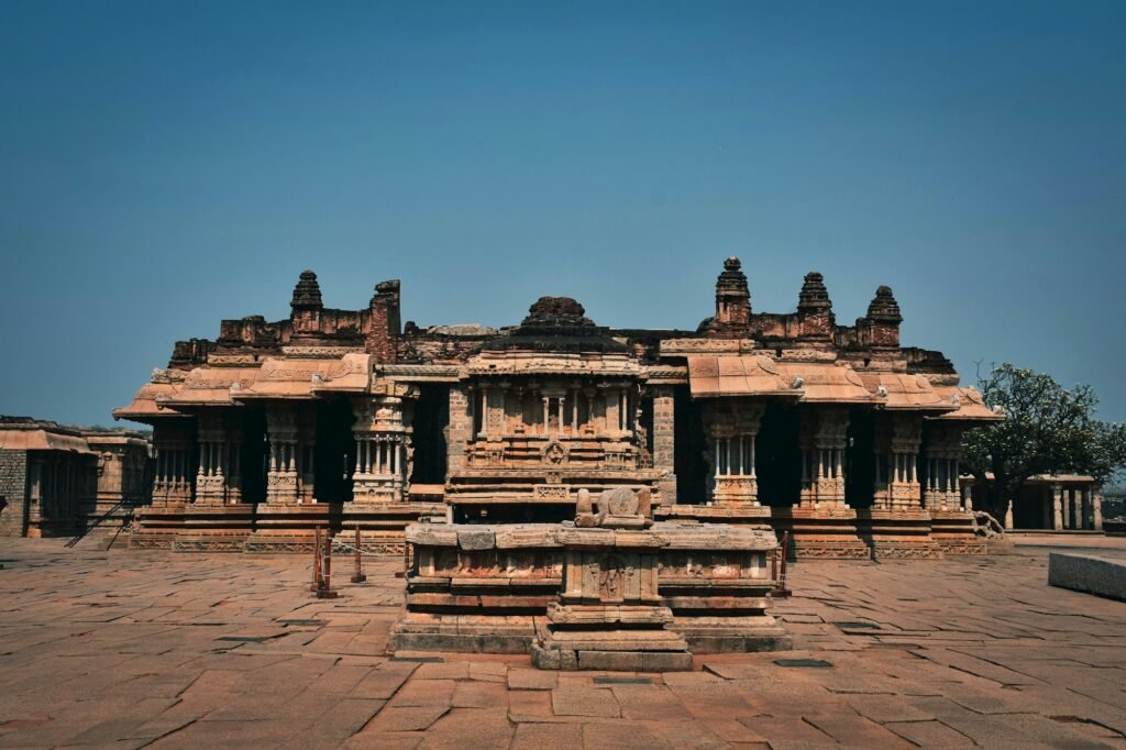 Stone pillared hall among the ruins of Hampi, one of the best places to visit in Hampi